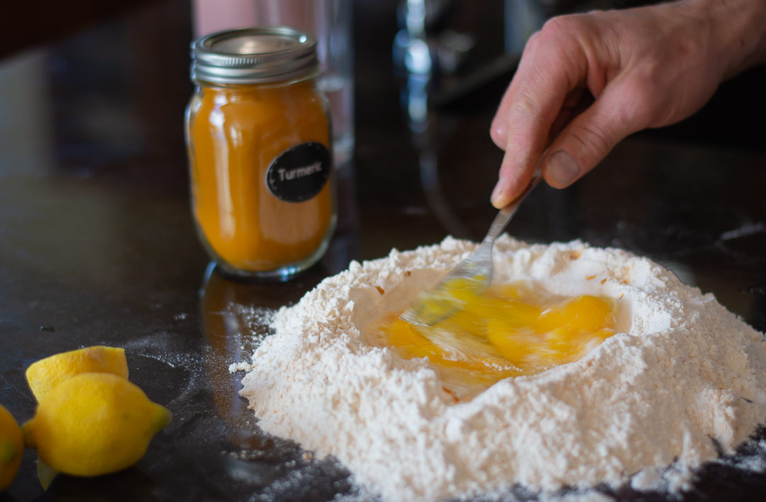 Beating egg into flour for pasta